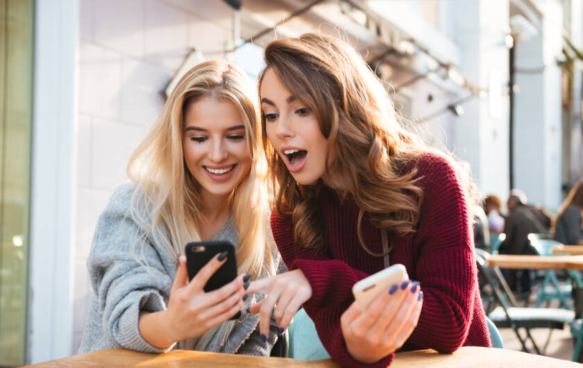 Two girls write messages